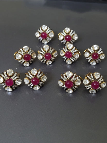 Gold and diamond earrings with red gemstones on a gray background