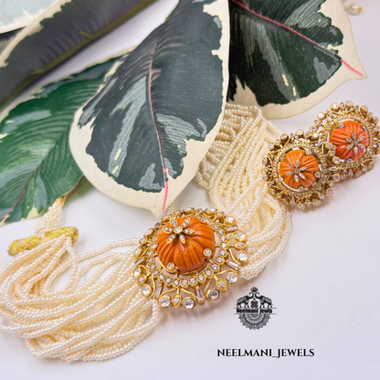 Gold pendant and studs with coral and emerald stones